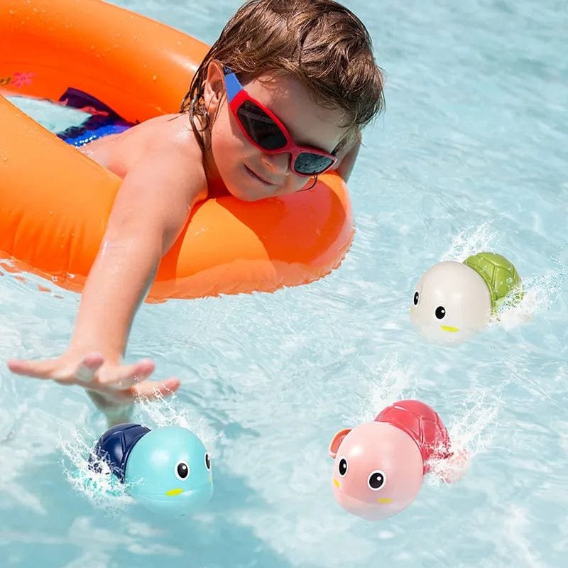 Child playing in a pool with colorful rubber duckies and an orange inflatable ring.