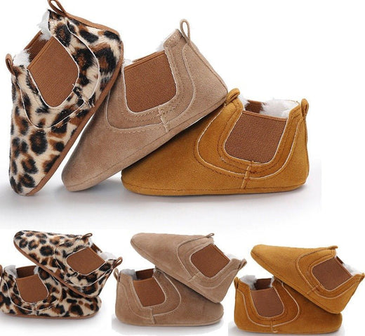 Pair of baby shoes with leopard print and brown suede on a white background