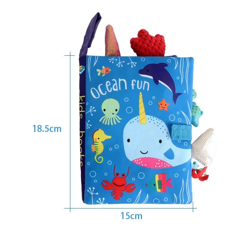 Children's soft book with ocean-themed illustrations and toys on a white background