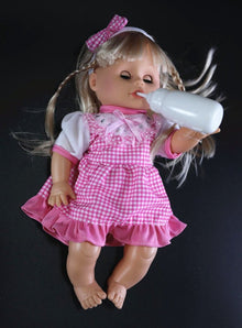 32cm interactive baby doll in a pink dress holding a bottle for feeding and peeing pretend play.