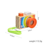 Wooden toy camera with colorful design and measurements on a white background
