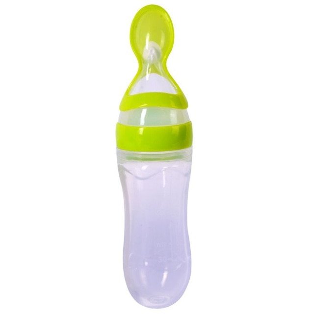Green baby feeding bottle with spoon on a white background
