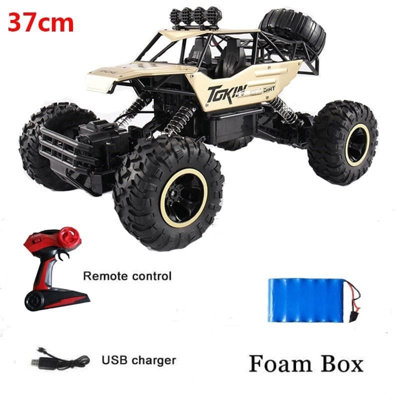Toy truck with remote control, USB charger, and foam box.