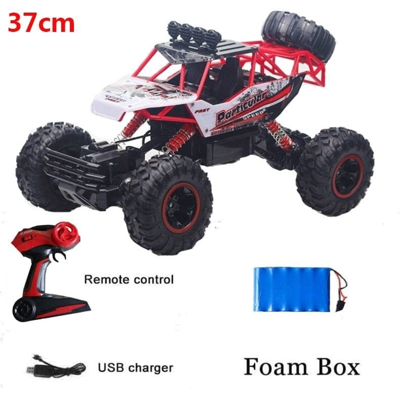 Remote control monster truck with remote control, USB charger, and foam box.
