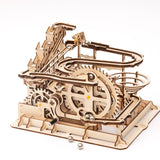 Wooden mechanical model with gears on a white background