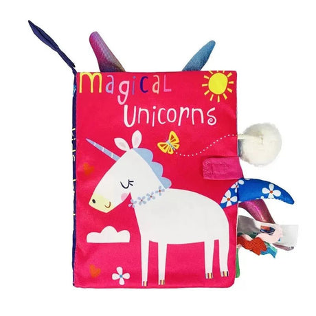 Children's soft book with unicorn illustration and 'magical unicorns' text on a pink cover.