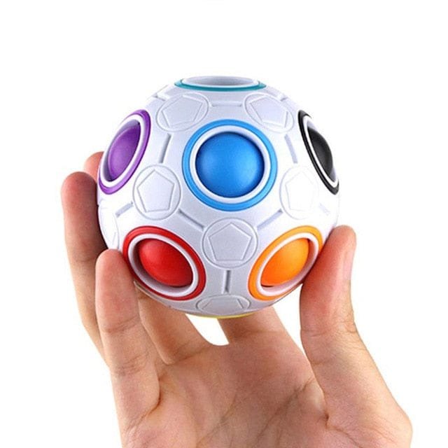 Colorful puzzle ball held in a hand against a white background
