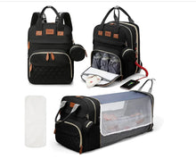 Black 3-in-1 diaper backpack with multiple compartments for organized baby gear on family outings.