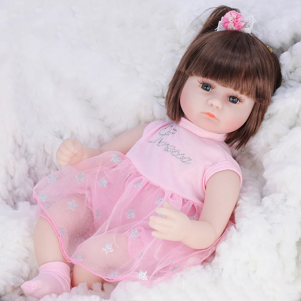Doll in a pink outfit with a bow on a white fluffy background
