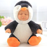 Baby doll dressed in a penguin costume with black, white, and orange colors on a light background.