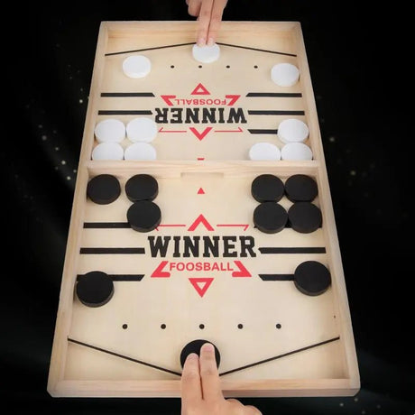 Wooden foosball table with 'Winner' branding on a black background
