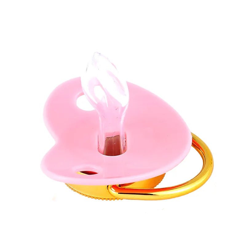 Pink pacifier with a gold clip on a white background