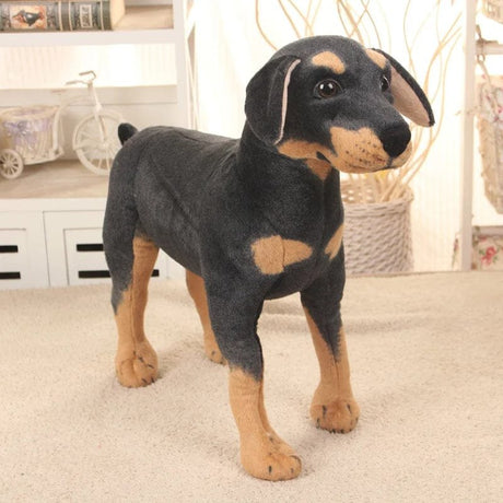 Plush toy resembling a Doberman Pinscher on a carpeted floor.