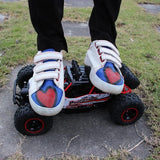Person wearing white sneakers with red and blue hearts on a small off-road vehicle.