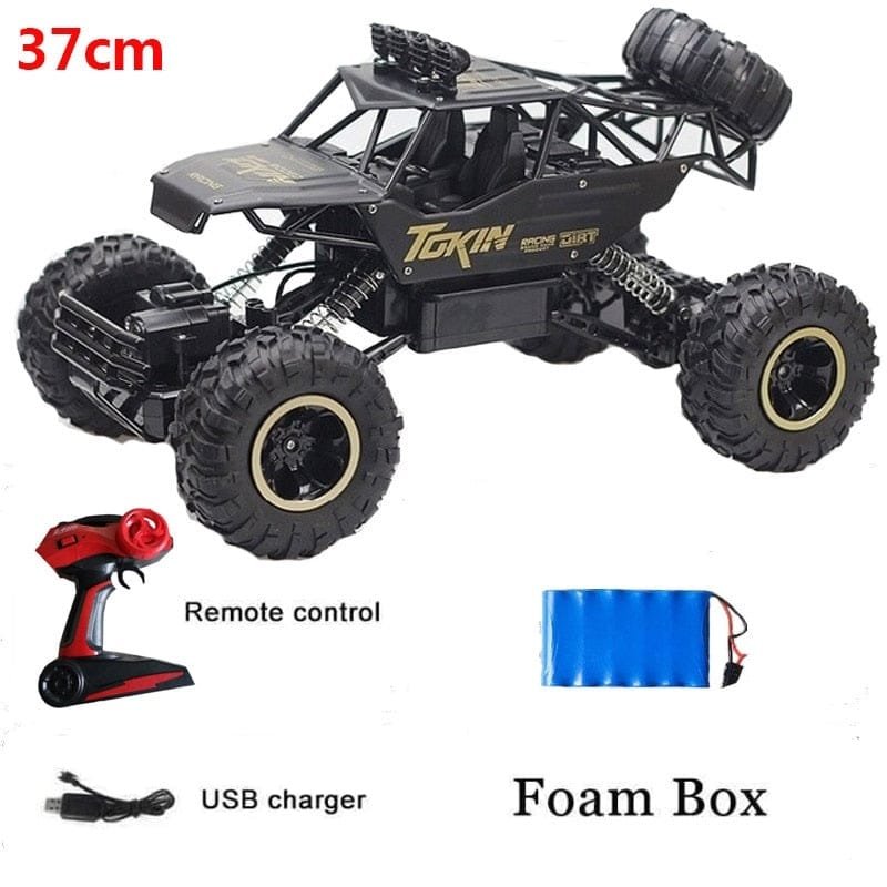Toy truck with remote control, USB charger, and foam box.