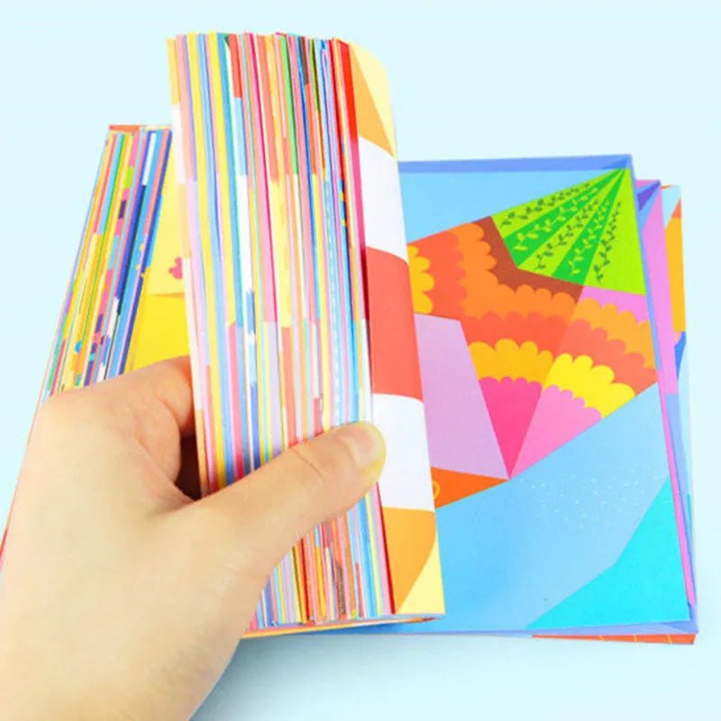 Colorful paper stacks held by a hand against a light blue background