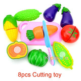 Colorful toy cutting vegetables set with a knife on a white background
