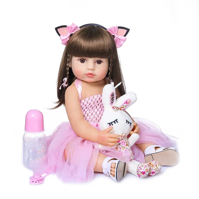 50CM Soft Silicone Reborn Doll in a cat-ear outfit holding a unicorn plush, a realistic toddler doll for imaginative play.
