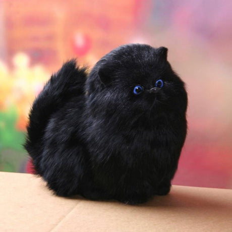 Black plush cat toy on a blurred colorful background