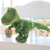 Green dinosaur plush toy on a white surface with a blurred background