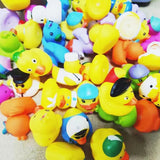 Assorted colorful rubber duck toys on a textured surface