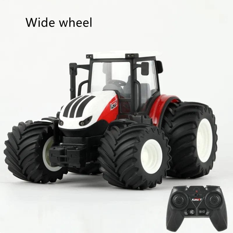 Toy tractor with wide wheels and a remote control on a white background