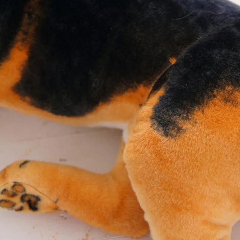 Close-up of a plush toy with black and orange fur on a white background