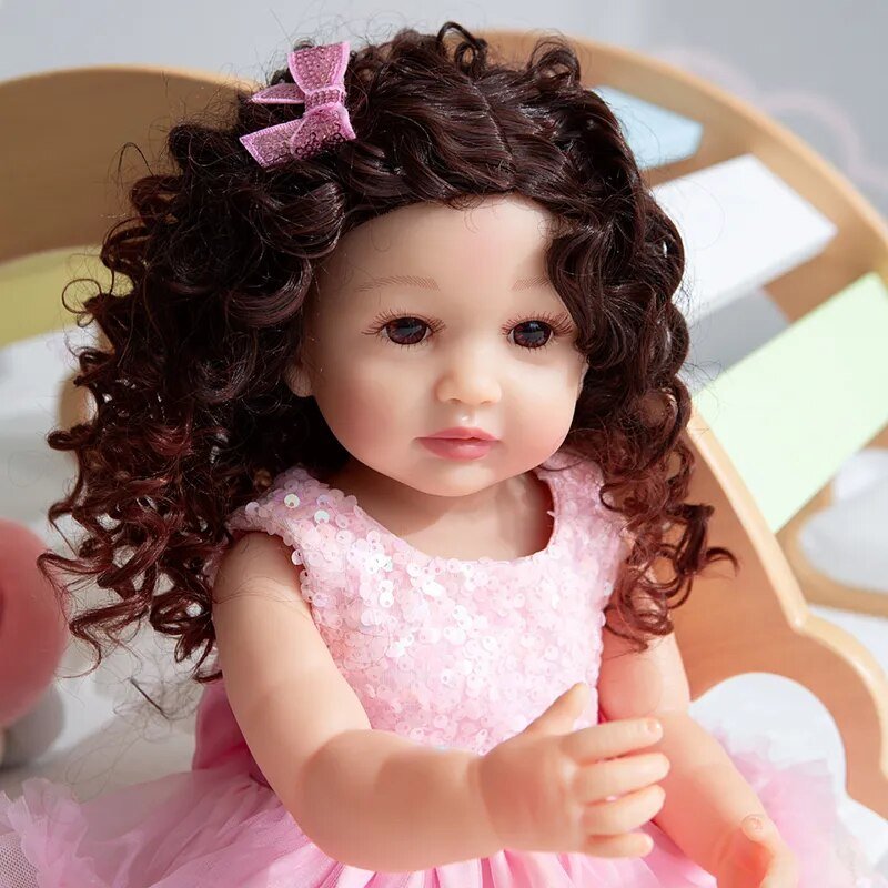 Fashion Reborn Toddler Doll with full body silicone and pink bow dress for soft feel play, birthday gifting, and doll display.