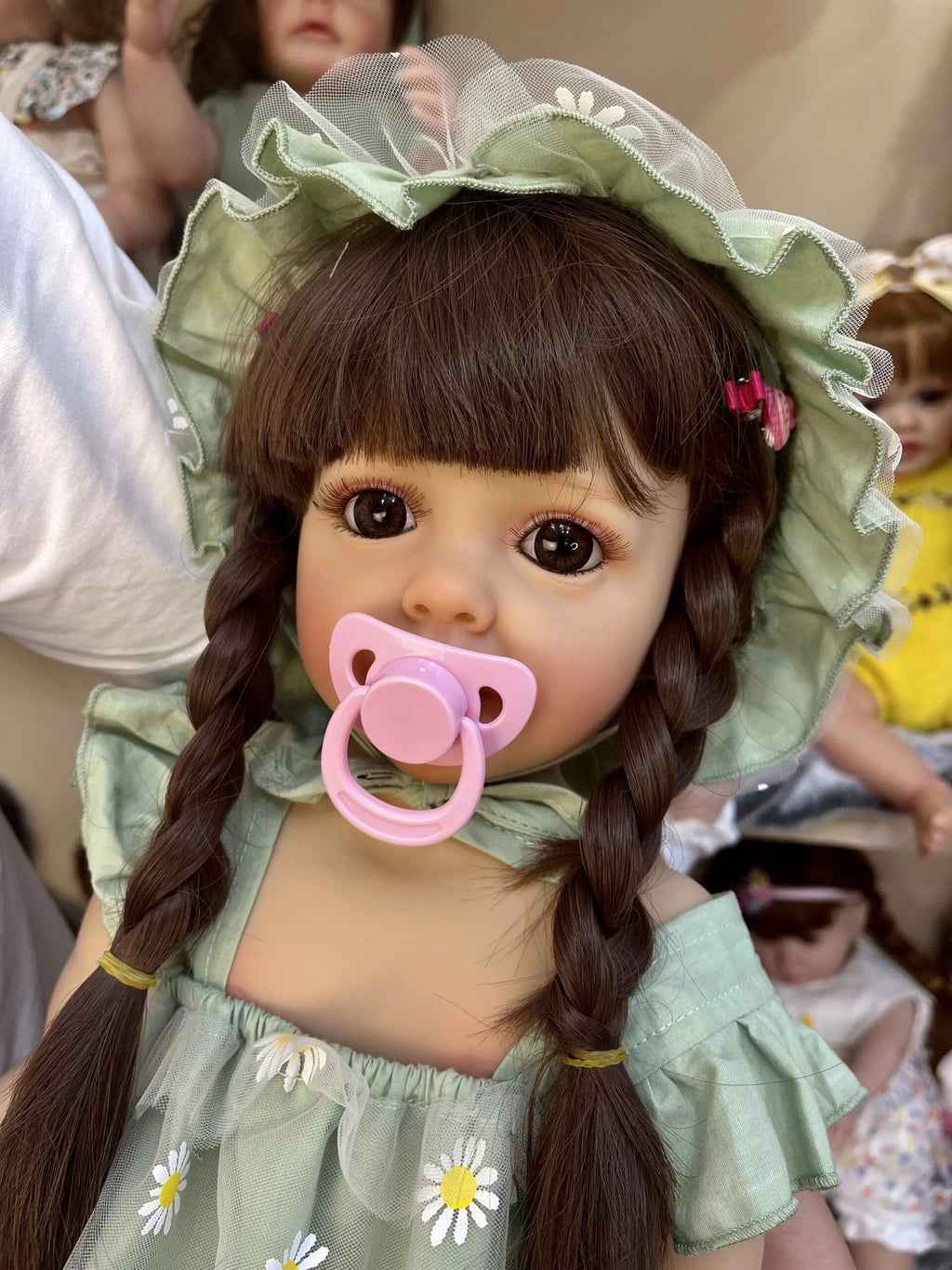 55CM Realistic Reborn Baby Doll Princess Betty in a hooded outfit with pacifier for lifelike pretend play and keepsake collecting.
