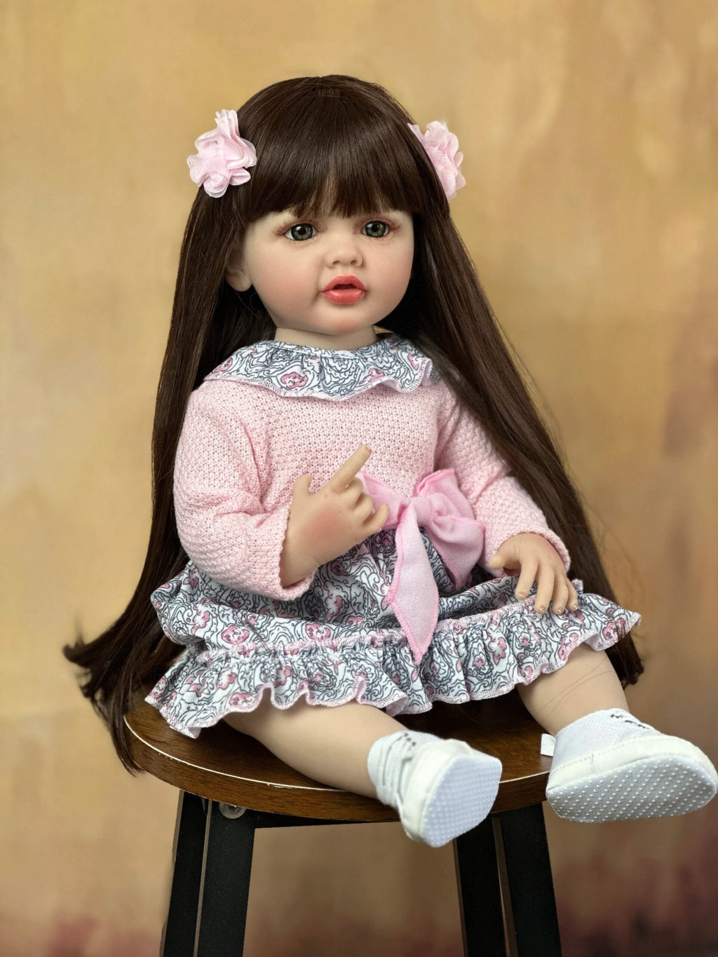 55cm Soft Silicone Reborn Baby Girl with lifelike long hair in a pink outfit for cuddling, nursery display, and doll collecting.