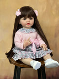 55cm Soft Silicone Reborn Baby Girl with lifelike long hair in a pink outfit for cuddling, nursery display, and doll collecting.