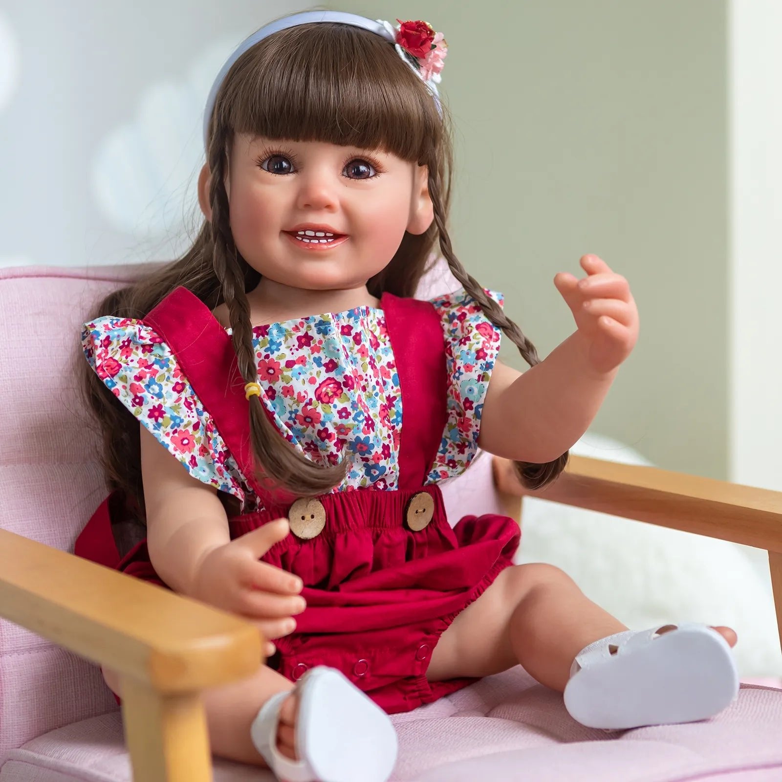 55CM Soft Silicone Reborn Doll Cammi Smile with long brown hair in a red dress and floral top for collecting and gifting.