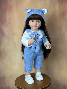 Standing Reborn Doll in a blue bear outfit arranged for display, a soft silicone baby doll for collecting and room decor.