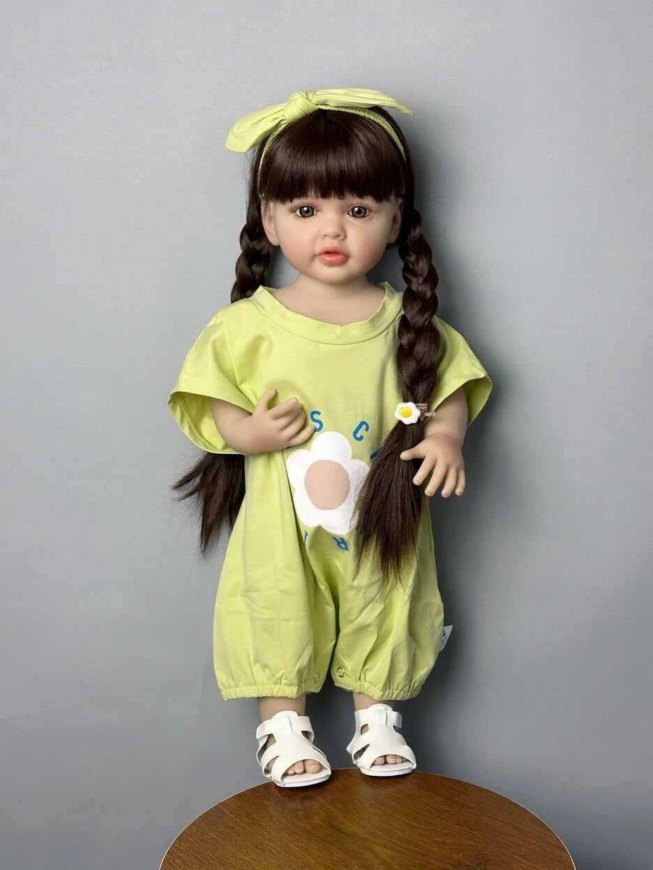 Standing Reborn Doll in a green outfit with a hair bow, an adorable soft silicone baby doll for gifting and gentle pretend play.