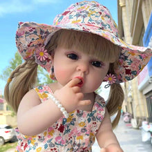 55cm Waterproof Reborn Doll in a floral hat and dress, a bathable silicone baby doll for garden pretend play and photo styling.