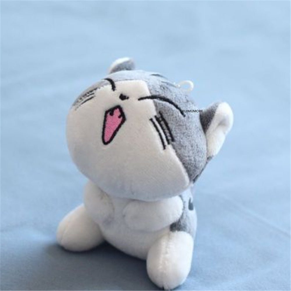 Plush toy cat with a happy expression on a light blue background