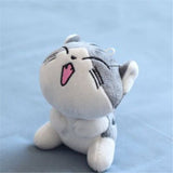 Plush toy cat with a happy expression on a light blue background
