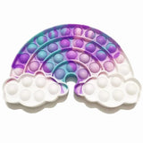 Rainbow-shaped pop-it fidget toy with bubble poppers on a white background
