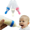 Baby bottle with colorful caps and a baby enjoying the milk.
