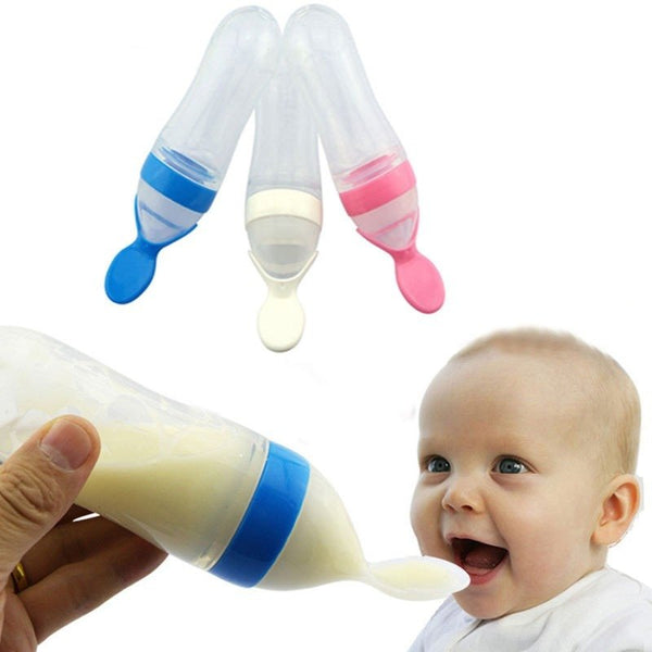 Baby bottle with colorful caps and a baby enjoying the milk.