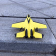 Yellow toy airplane on a concrete surface