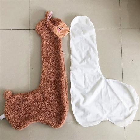 Brown and white llama-shaped bath towels on a tiled floor