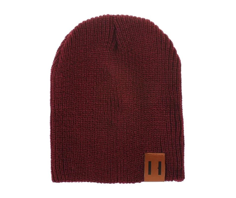 Maroon knit beanie with a brown patch on a white background