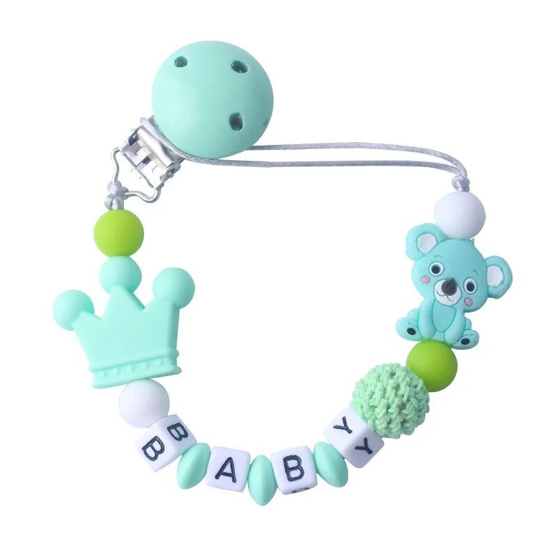 Mint green baby teether with bear and crown design on a white background