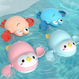 Three colorful bath toys, including a pink penguin, blue octopus, and orange crab, floating in water.