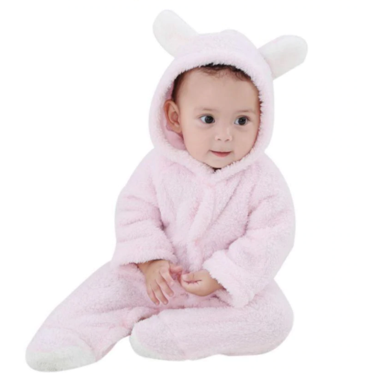 Baby in a pink fluffy costume with bunny ears on a white background