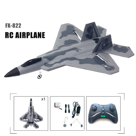 Camouflage RC airplane with remote control and accessories on a white background