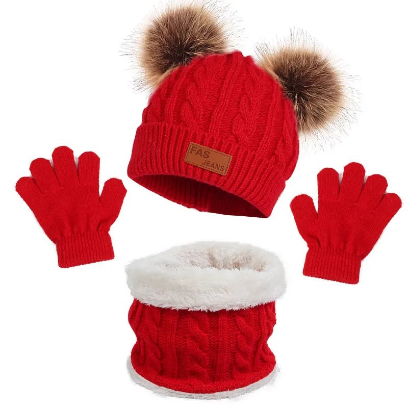 Red knit hat with pom-poms, red gloves, and red knit scarf with white fur lining on a white background.