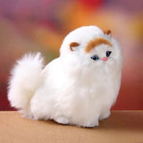 White plush toy resembling a fluffy animal with brown ears on a blurred background