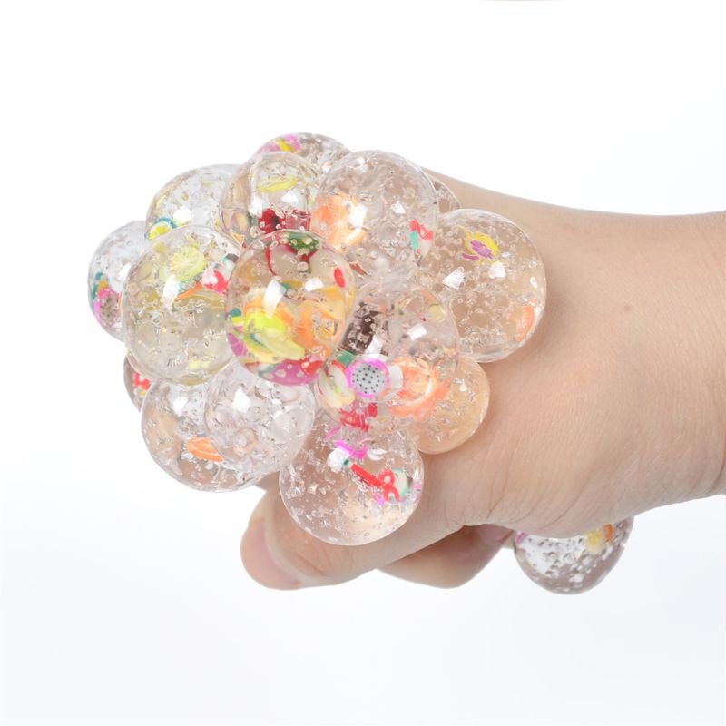 Hand holding a colorful squishy ball.
